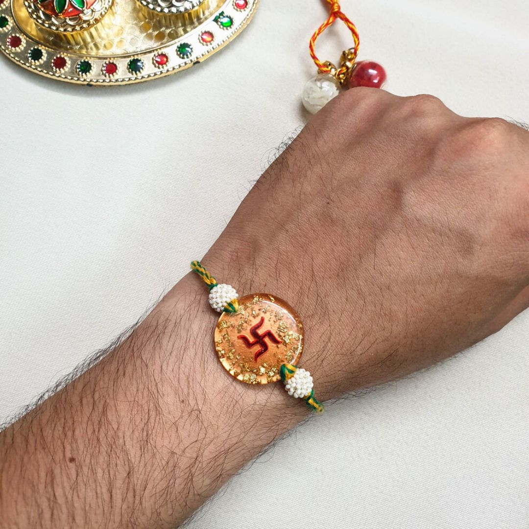 Swastik Rakhi Filled With Gold Flake